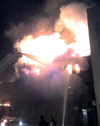 Fire fighters concentrate water streams through one window.